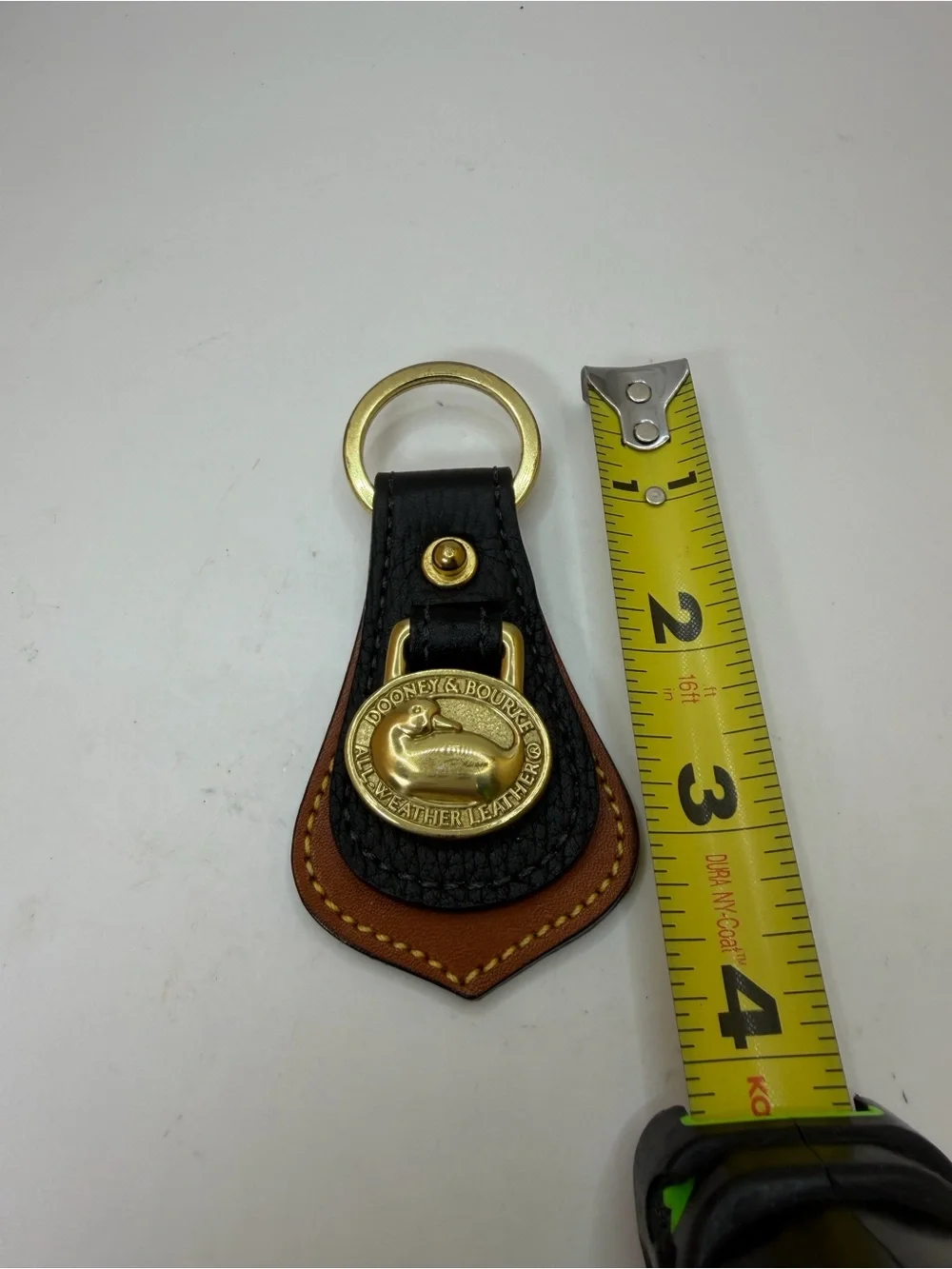 Dooney & Bourke Black and Brown Leather Key Fob with Brass Duck Medallion